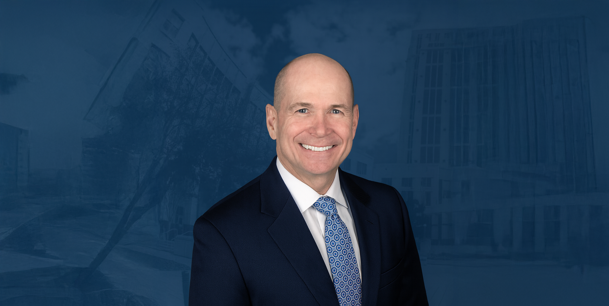 Smiling personal injury lawyer in a suit standing in front of downtown Orlando courthouse buildings